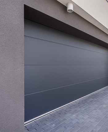 Dark garage door from a driveway