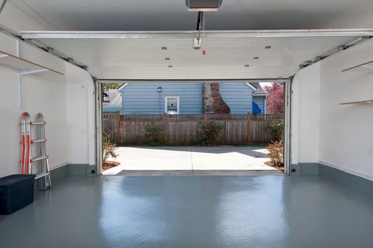 Open residential garage door and driveway
